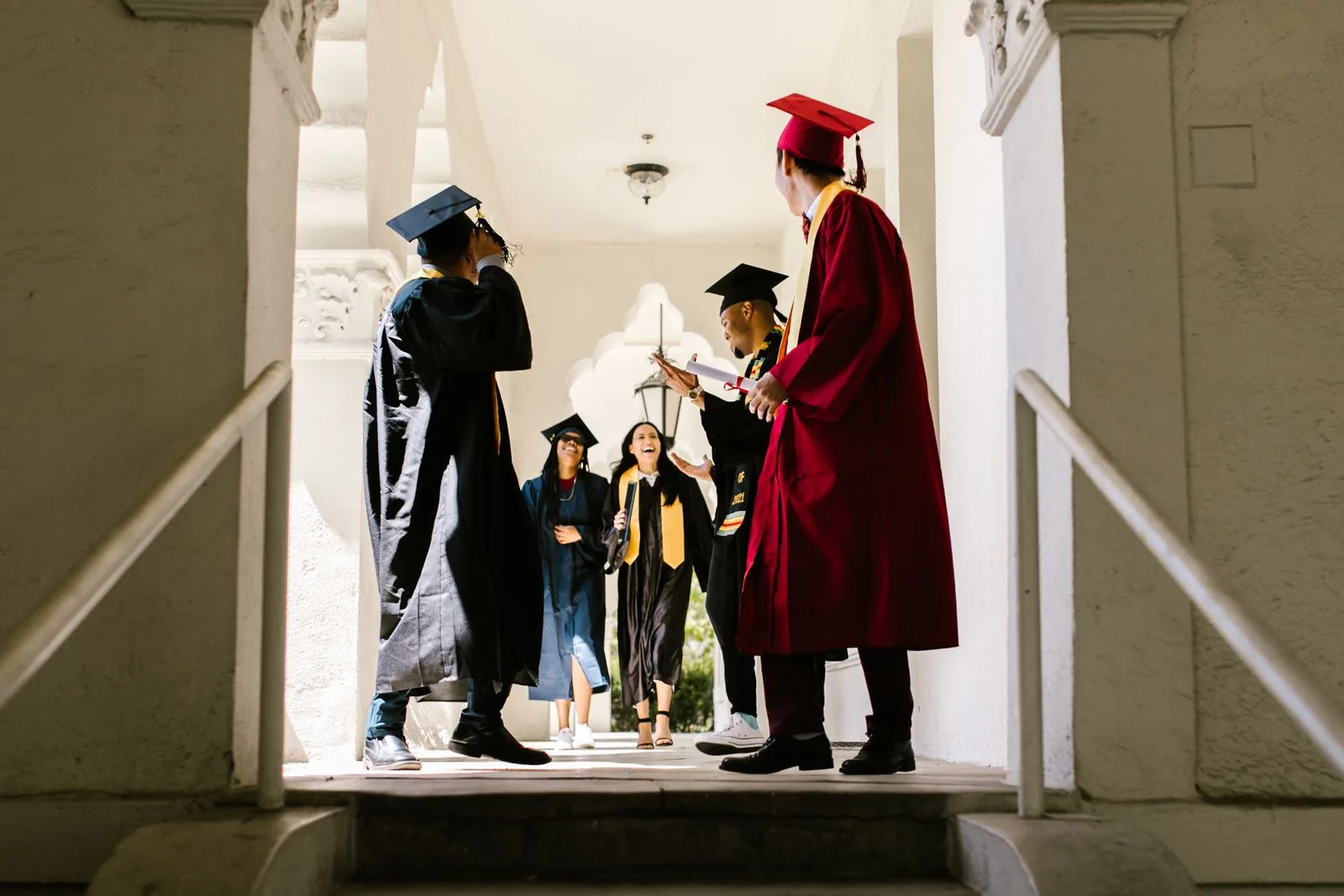 University graduates celebrating in a campus hallway